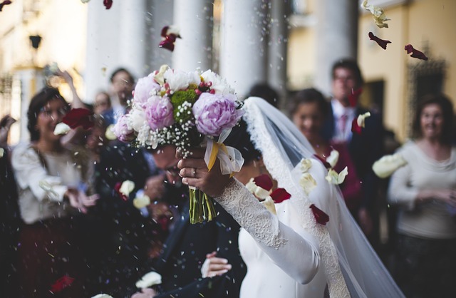 a photo of a bride holding her buquet high above her head