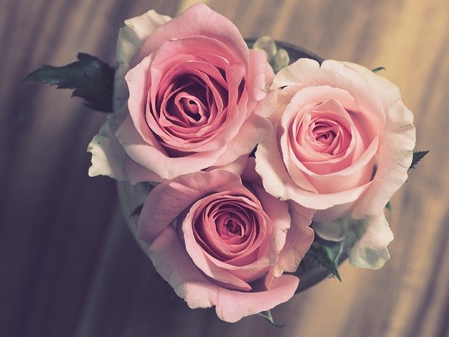 a vase full of roses on a wedding day